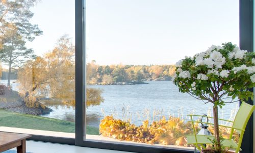 A beautiful view of a blue lake captured from the inside of a villa