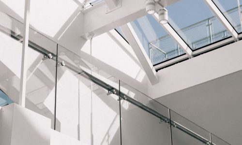 A low angle shot of a modern building interior with white walls touching the sky
